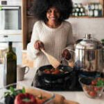 a woman cooking in a kitchen