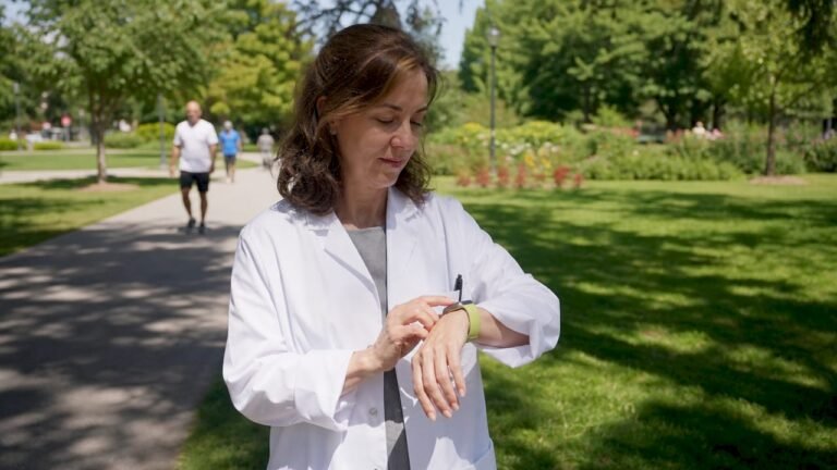 American female doctor checking walking app at home